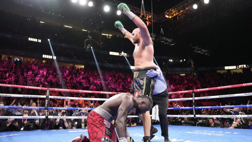 WBC heavyweight champion Tyson Fury (standing) dropped Deontay Wilder once each in the third, 10th (above) and final rounds of his 11th-round TKO victory on Oct. 9, twice rising from the canvas in the fourth round to do so. (Sean Michael Ham/TGB Promotions)