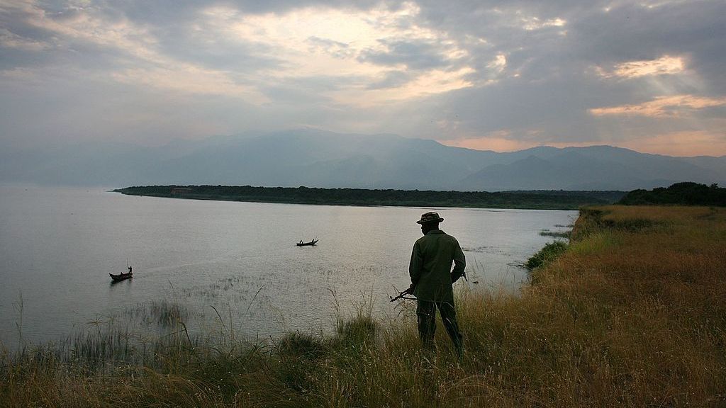 A Congolese park ranger looks over Lake Edwards July 21, 2006, in the Virunga National Park in eastern Democratic Republic of Congo. After years of war in eastern Congo, the international community and Congolese conservation authorities are trying save the country's remaining wildlife, including by training new park rangers in paramiitary techniques to stop poachers. (John Moore/Getty Images)