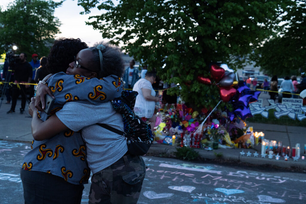 Two women embrace at a vigil for the victims of the racially motivated May 14, 2022, mass shooting at a supermarket on Buffalo's predominantly Black East Side. Photo credit: Joshua Therimdor