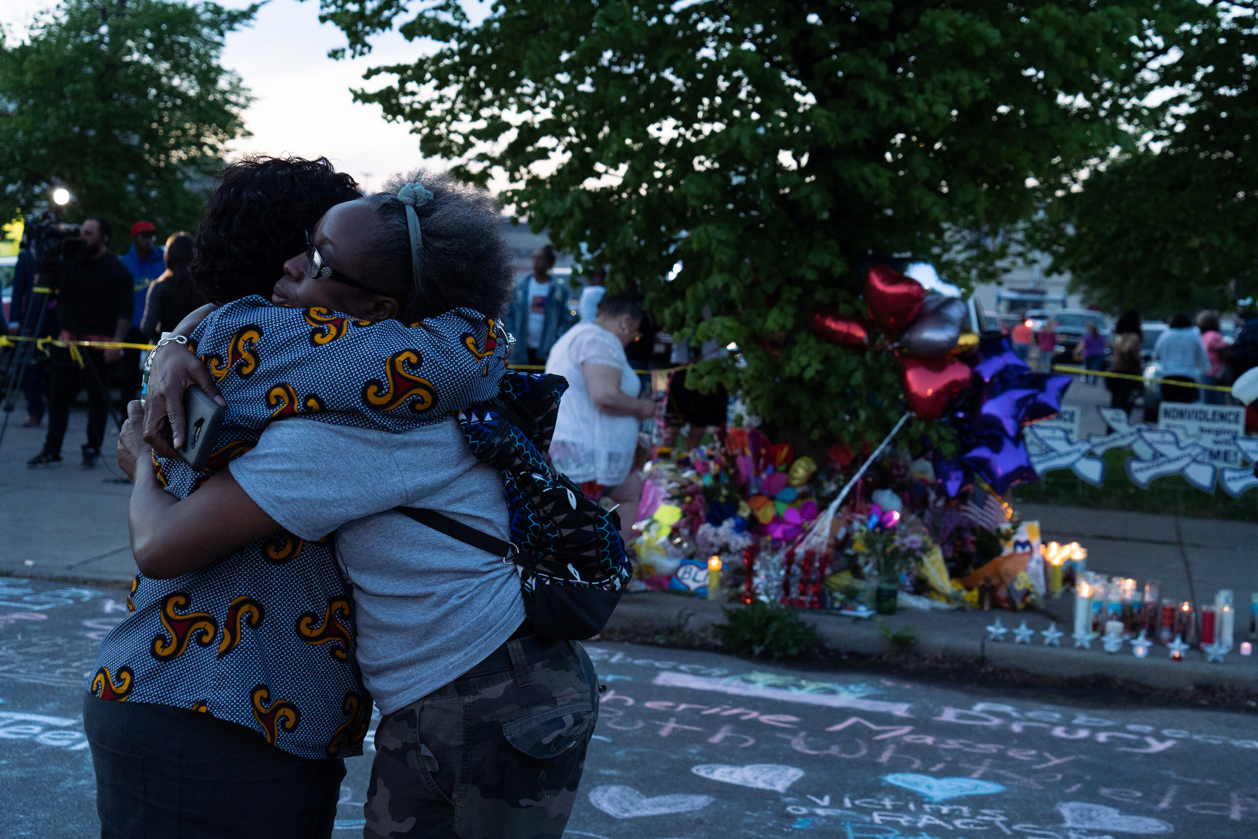 Two women embrace at a vigil for the victims of the racially motivated May 14, 2022, mass shooting at a supermarket on Buffalo's predominantly Black East Side. Photo credit: Joshua Therimdor