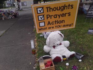 A makeshift memorial has cropped up outside of Tops Friendly Markets grocery store on Buffalo's predominantly Black East Side. On May 14, 2022, a gunman killed 10 people and wounded three in a racially motivated mass shooting. Photo credit: Nanette D. Massey. 