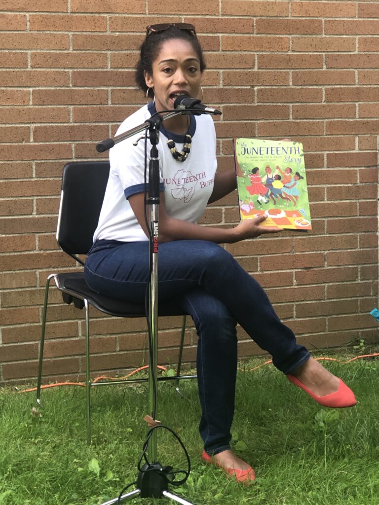 Author Alliah Agostini reads the Juneteenth story to children at the Montclair, N. J. Public Library. Photo credit: Sandra Dawson Long Weaver