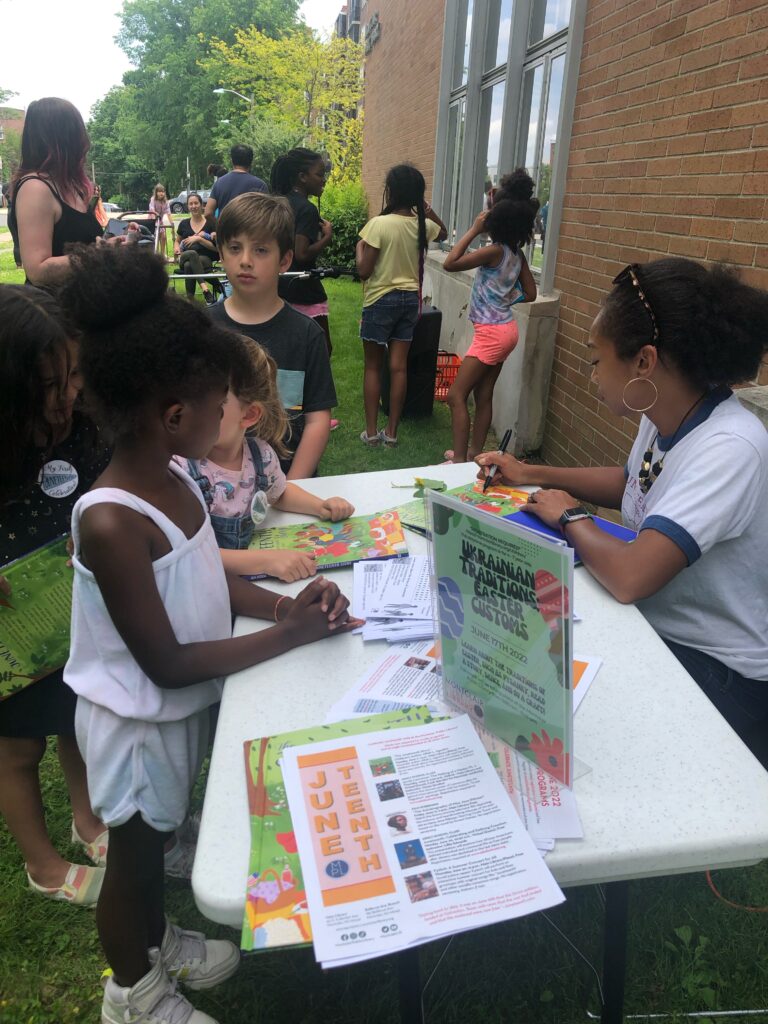 Children gather around author Alliah Agostini during a book signing in June in Montclair, New Jersey, for her book, "The Juneteenth Story: Celebrating the End of Slavery in the United States."