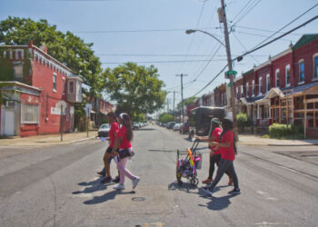 PlayStreets staff head to Pennsgrove Street in West Philadelphia where they’ll be facilitating games and crafts with neighborhood kids on their first day of work, July 11, 2022. (Kimberly Paynter/WHYY)