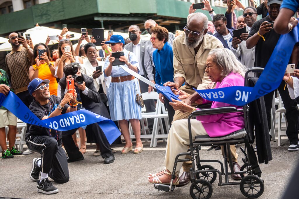 Rachel Robinson, widow of late athlete and civil rights activist Jackie Robinson, cuts the ribbon for the Jackie Robinson Museum in Lower Manhattan on Tuesday, July 26, 2022. Filmmaker Spike Lee takes a picture during the event. Photo credit: Michael Appleton, Mayoral Photography Office
