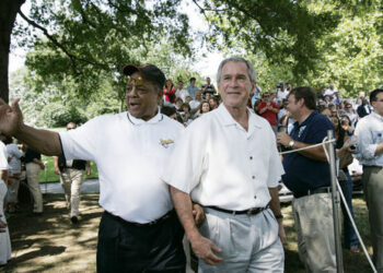 Baseball legend and hall of famer Willie Mays walks with President George W. Bush as he acknowledges a standing ovation from the crowd Sunday, July 30, 2006, upon their arrival for the Tee Ball on the South Lawn game between the Thurmont Little League Civitan Club of Frederick Challengers of Thurmont, Maryland, and the Shady Spring Little League Challenger Braves of Shady Spring, West Virginia. Mays was the honorary Tee Ball commissioner for the game. Photo credit: Paul Morse, White House