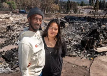 DeAndre Thomas and his wife, Elizabeth, in the wreckage of their home in the Lincoln Heights neighborhood. Michael Kodas