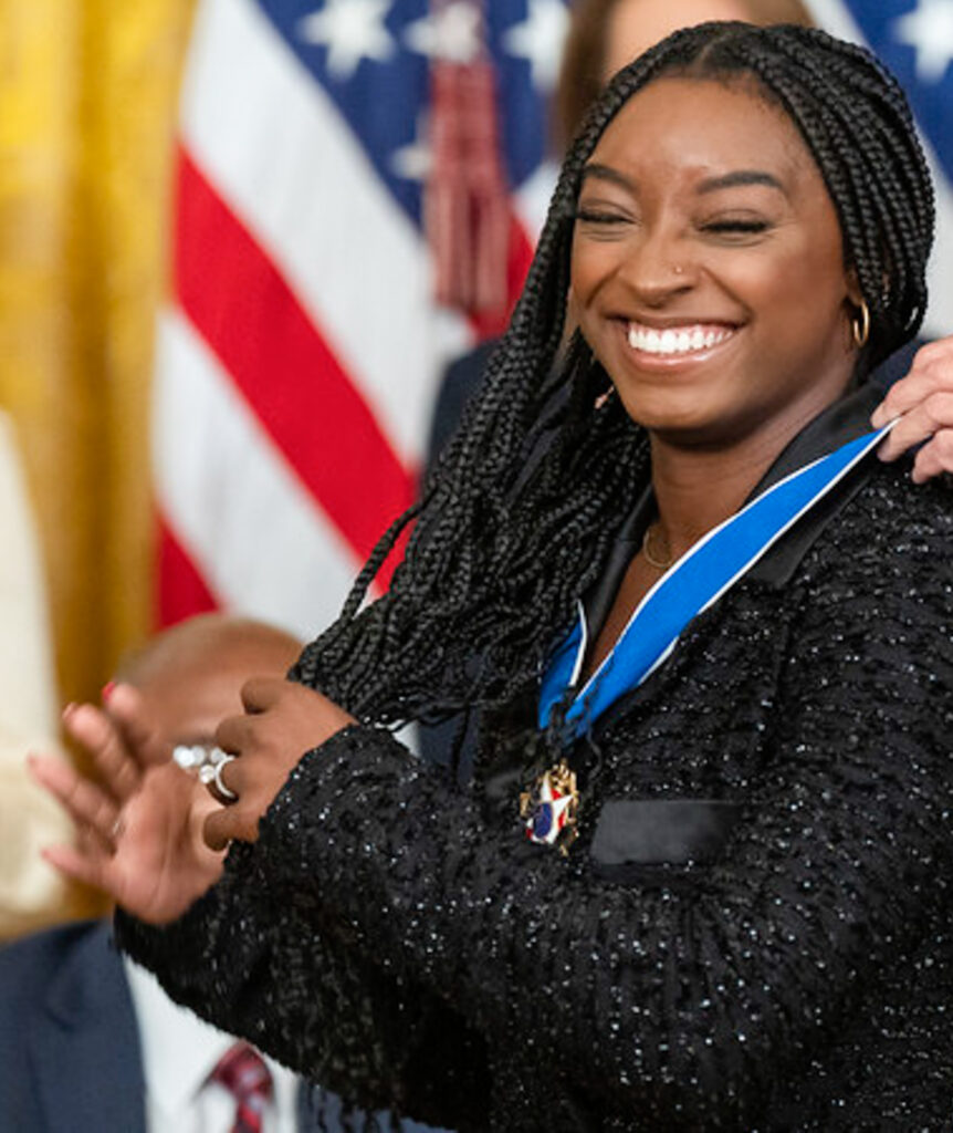President Joe Biden presents the Medal of Freedom to gymnast Simon Biles, Thursday, July 7, 2022, in the East Room of the White House. Photo credit: Simone Biles, Adam Schultz