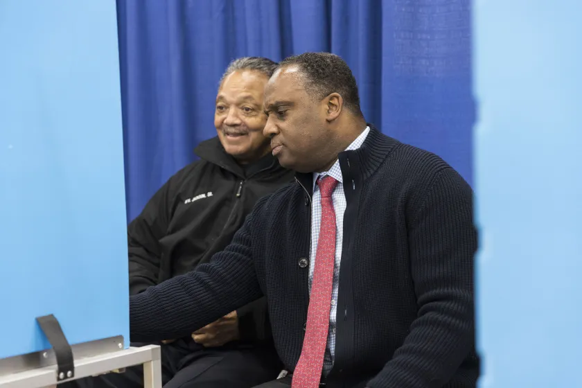 Jonathan Jackson (right) alongside his father, Rev. Jesse Jackson, fills out a ballot Monday at the Dr. Martin Luther King Center Service Center at 4314 S. Cottage Grove Ave. Anthony Vazquez/Sun-Times