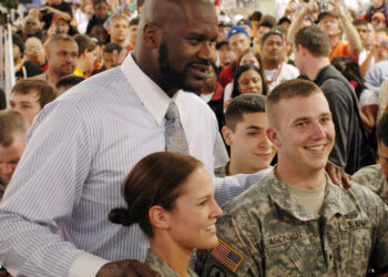 Army National Guard members Staff Sgt. Maygen Matson, left, and Spc. Taylor Anonson pose for a photo with National Basketball Association superstar Shaquille O'Neal during NBA All-Star Weekend in Phoenix, Feb. 15, 2009. Photo credit: Tech. Sgt. Angela Walz, U.S. Air Force