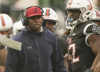 ThenJackson State head coach Deion Sanders glares at his players as they exit the field during the seco
