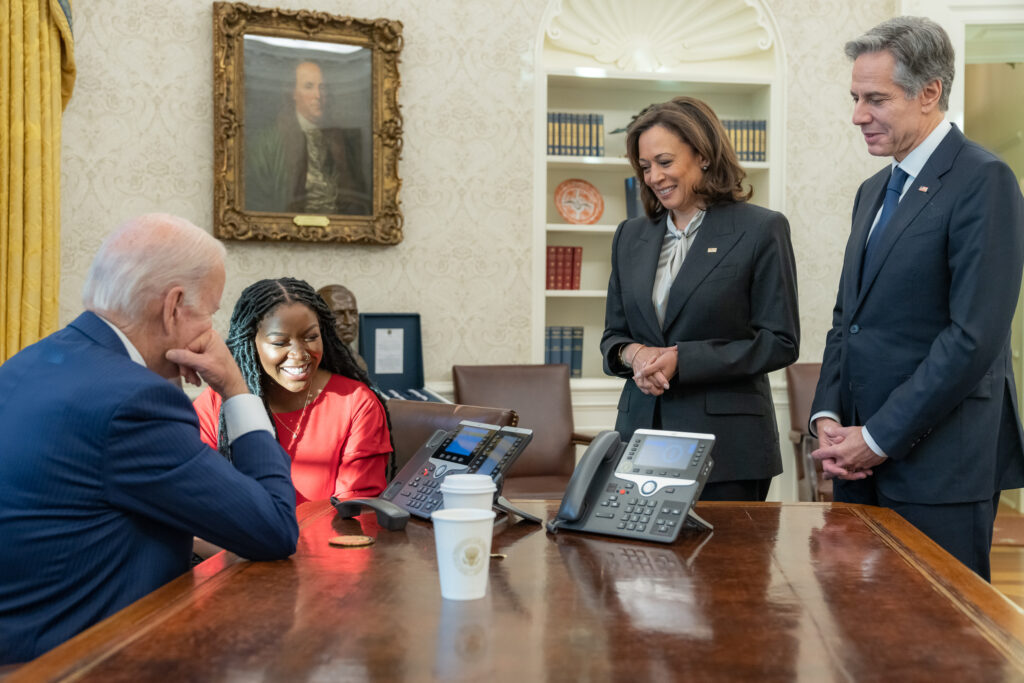 President Biden and Vice President Harris speak on the phone with WNBA star Brittney Griner on Thursday, Dec. 8, 2022, from the Oval Office after the administration negotiated her release from a Russian prison. Between them is Griner's wife, Cherelle Griner, and next to Harris is U.S. Secretary of State Antony Blinken. (Photo credit: Adam Schultz, The White House)
