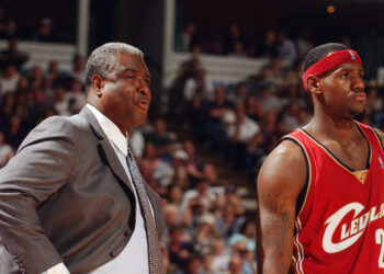 Late Cleveland Cavaliers head coach Paul Silas, left, and number 23 LeBron James, formerly of the Cavaliers, look on during an Oct. 29, 2003, away game against the Sacramento Kings at Arco Arena in Sacramento, California. The Kings won 106-92. Photo credit: Andrew D. Bernstein/NBAE via Getty Images