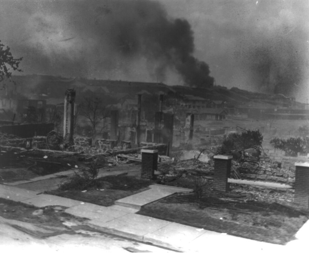 The remains of homes ruined in the Tulsa (Oklahoma) Race Massacre smolder. Photo credit: Alvin C. Krupnick; Library of Congress