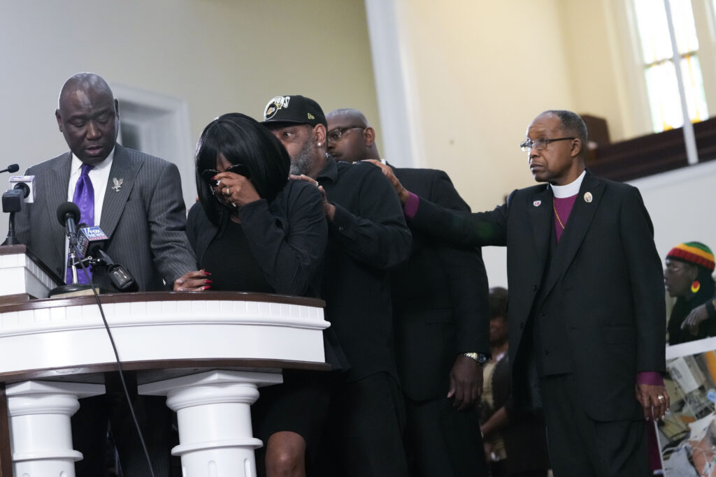 RowVaughn Wells, second from left, mother of Tyre Nichols, who died after being beaten by five Memphis police officers, cries as she is comforted by Tyre's stepfather Rodney Wells, behind her, at a news conference with civil rights Attorney Ben Crump, left, in Memphis, Tennessee on Monday, Jan. 23, 2023. Photo credit:Gerald Herbert, The Associated Press