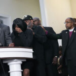 RowVaughn Wells, second from left, mother of Tyre Nichols, who died after being beaten by Memphis police officers, cries as she is comforted by Tyre's stepfather Rodney Wells, behind her, at a news conference with civil rights Attorney Ben Crump, left, in Memphis, Tenn., Monday, Jan. 23, 2023. Far right is Bishop Henry Williamson. Photo credit:Gerald Herbert, The Associated Press