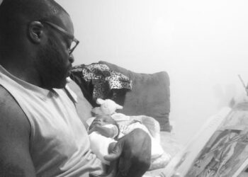 BNV staffer Damon Jackson reading to his son, Jireh, when Jireh was an infant. Jireh is now 7. Photo credit: Tamara Jackson