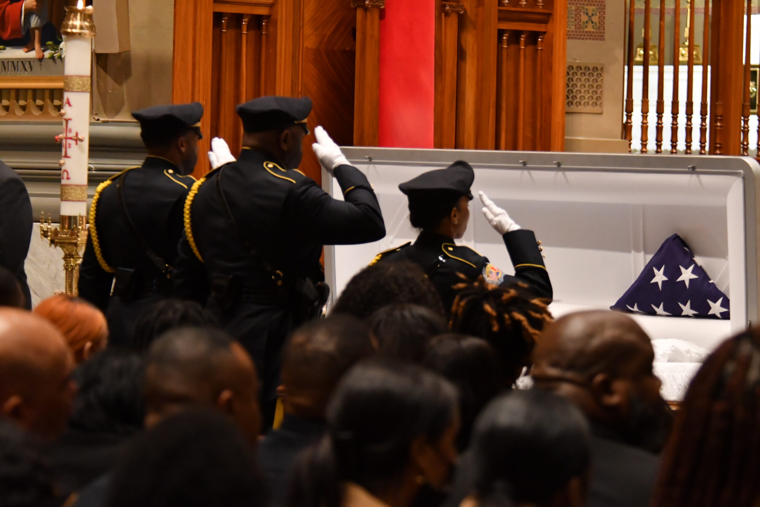 Law enforcement officers salute the casket during Friday's funeral services for slain Temple University police officer Christopher Fitzgerald, who was killed in the line of duty Feb. 18. He was 31. Photo credit: Abdul R. Sulayman, The Philadelphia Tribune