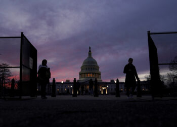 A perimeter fence around the U.S. Capitol is open for visitors to pass at sunset on Sunday, Feb. 5, 2023, in Washington, ahead of President Joe Biden's State of the Union address on Tuesday. Photo credit: Carolyn Kaster, The Associated Press