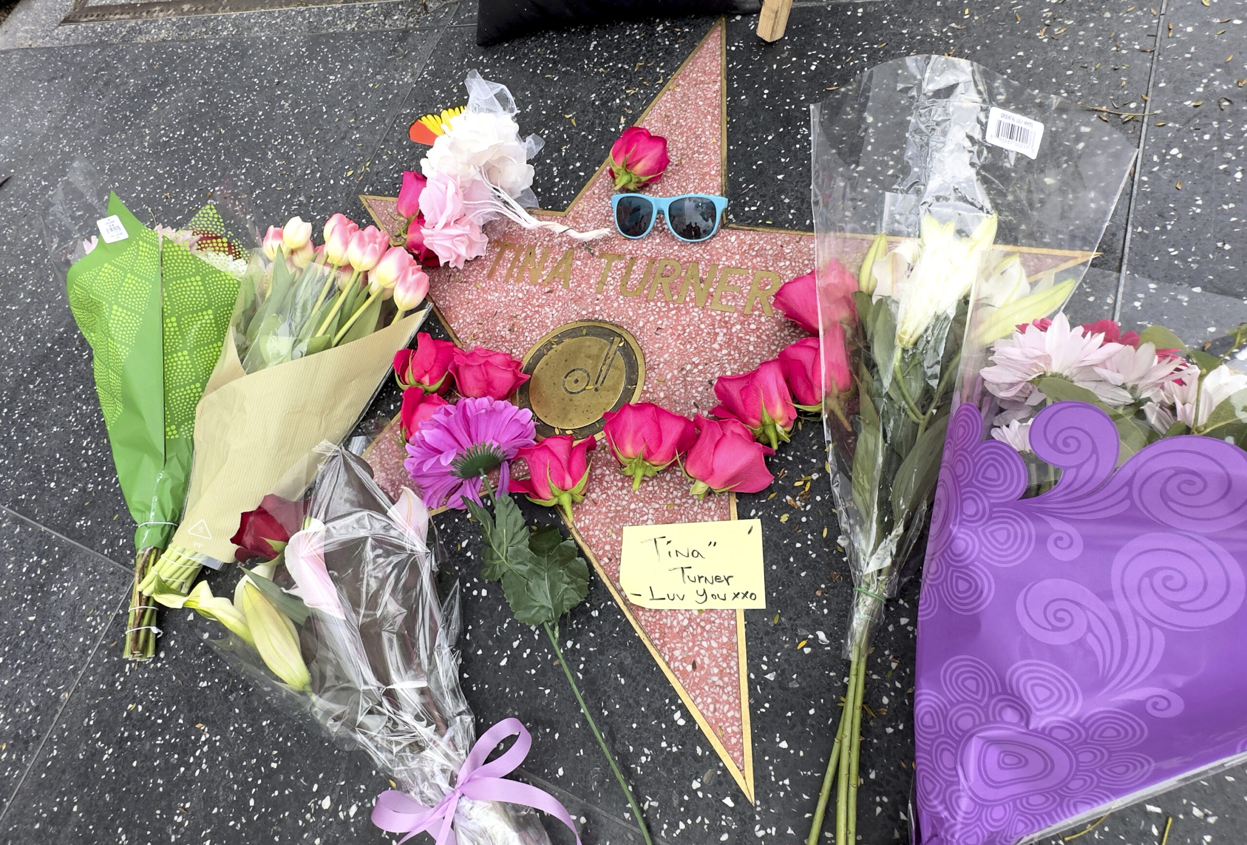 Flowers and tributes appear on Tina Turner's star on the Hollywood Walk of Fame on Wednesday, May 24, 2023, in Los Angeles. Turner, the unstoppable singer and stage performer with hits like "What's Love Got to Do With It," died Tuesday after a long illness at her home in Küsnacht near Zurich, Switzerland, according to her manager. She was 83. Photo credit: Rick Taber, The Associated Press