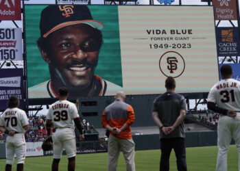 San Francisco Giants players and staff observe a moment of silence for former player Vida Blue before a baseball game between the Giants and the Milwaukee Brewers in San Francisco, Sunday, May 7, 2023. Blue died May 6, 2023. He was 73. Photo credit: Jeff Chiu, The Associated Press