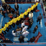A line of security separates Mike Tyson, top, from Lennox Lewis in the ring before their heavyweight championship fight at The Pyramid in Memphis, Tennessee, Saturday, June 8, 2002. Photo credit: Mark J. Terrill, The Associated Press