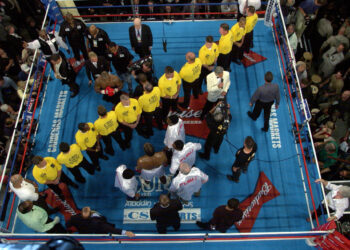 A line of security separates Mike Tyson, top, from Lennox Lewis in the ring before their heavyweight championship fight at The Pyramid in Memphis, Tennessee, Saturday, June 8, 2002. Photo credit: Mark J. Terrill, The Associated Press