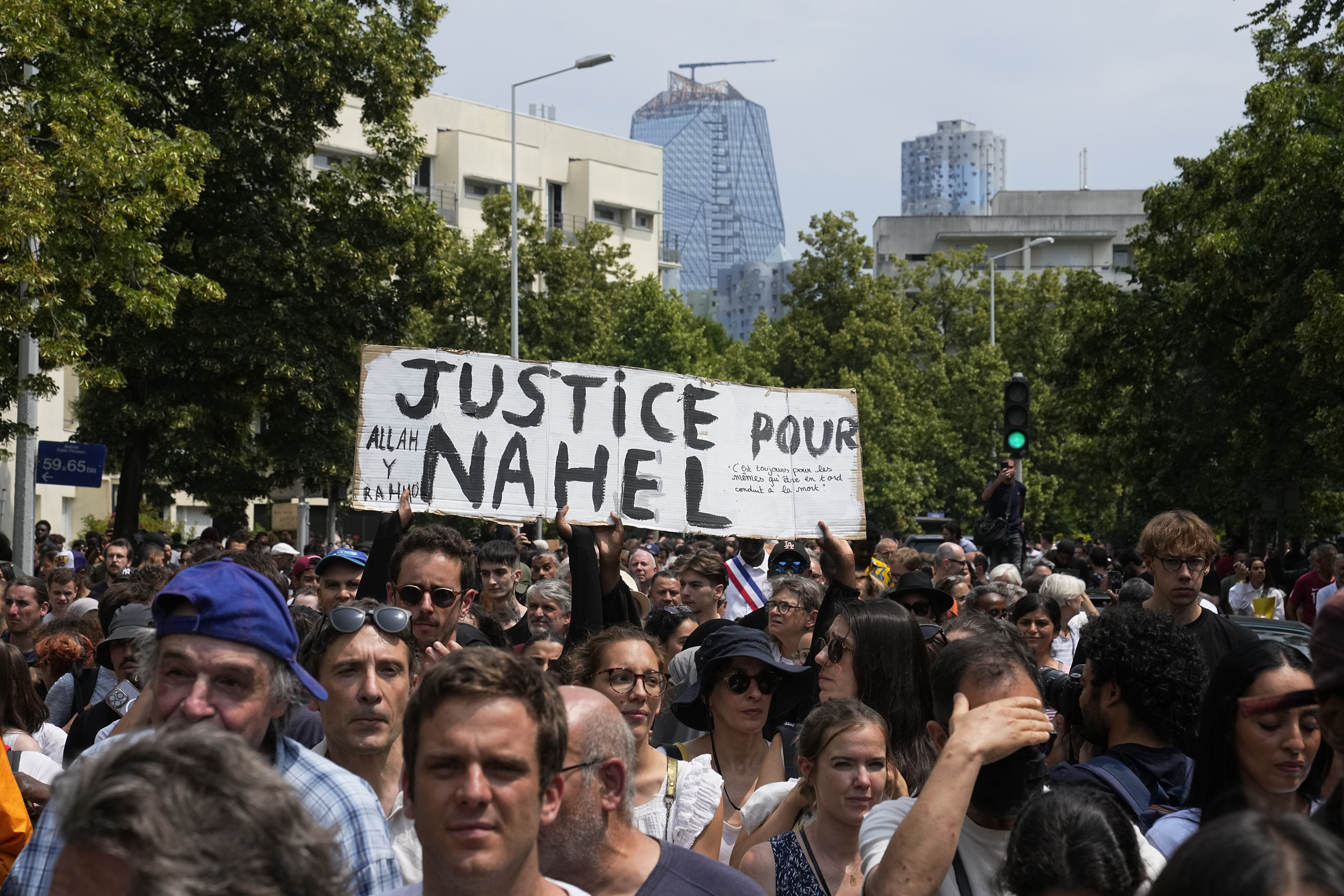 Demonstrators carry a poster reading "Justice for Nahel" during a march for 17-year-old Nahel, Thursday, June 29, 2023, in Nanterre, outside Paris. The killing of Nahel during a traffic stop Tuesday, captured on video, shocked the country and stirred up long-simmering tensions between young people and police in housing projects and other disadvantaged neighborhoods around France. Photo credit: Michel Euler, The Associated Press