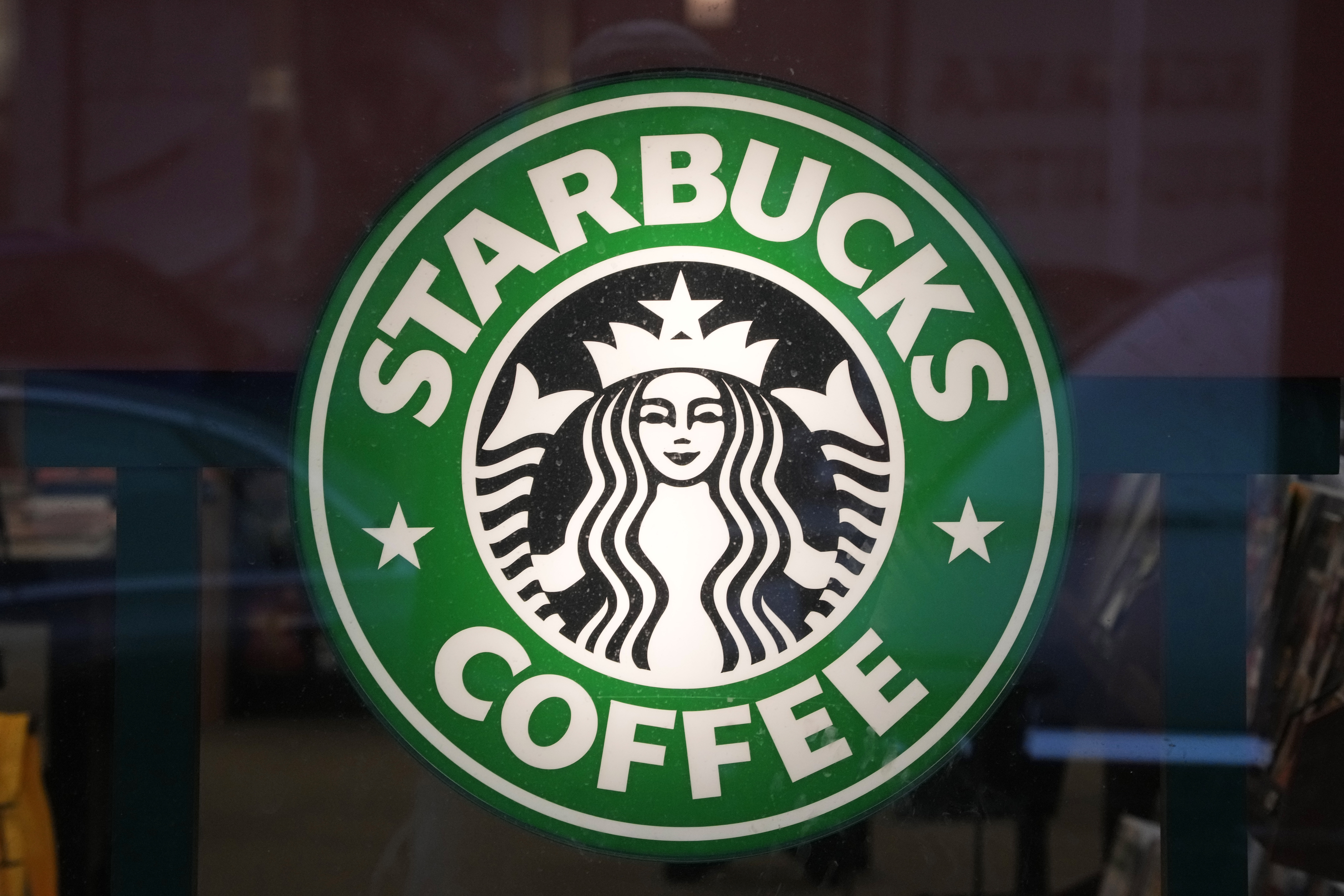 The Starbucks sign is displayed in the window of a Pittsburgh Starbucks, Jan. 30, 2023. On Monday, June 12, jurors in a federal court in New Jersey awarded $25.6 million to a former regional Starbucks manager who alleged that she and other white employees were unfairly punished by the coffee chain after the high-profile 2018 arrests of two Black men at one of the chain's Philadelphia locations. Photo credit: Gene J. Puskar, The Associated Press