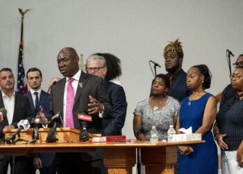 Civil rights lawyer Ben Crump, speaking, stands with relatives of the victims of the May 2022 mass shooting in Buffalo, New York, along with their lawyers. All took part in a press conference in Buffalo on Wednesday, July 12, 2023. Relatives of the victims of last year's mass shooting at Tops Friendly Market announced Wednesday they are suing the social media sites, weapons retailers and others who they say “loaded the gun” that convicted assailant Payton Gendron in the attack fueled by racist conspiracy theories he encountered online. Photo credit: Libby March, The Buffalo News via The Associated Press