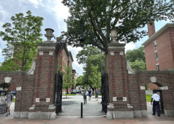 Students walk through a gate at Harvard University Thursday, June 29, 2023, in Cambridge, Massachusetts. The Supreme Court on Thursday struck down affirmative action in college admissions, declaring race cannot be a factor and forcing institutions of higher education to look for new ways to achieve diverse student bodies. Photo credit: Michael Casey, The Associated Press.