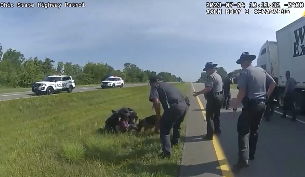 This image taken from police body cam video shows a police dog attacking Jadarrius Rose, 23, of Memphis, Tennessee, on Tuesday, July 4, 2023, in Circleville, Ohio. An Ohio police department has fired an officer who released his police dog on Rose -- even after state troopers told him to hold the dog back. A statement issued Wednesday, July 26, 2023, by Circleville police said Ryan Speakman “did not meet the standards and expectations we hold for our police officers” and that he has been “terminated from the department, effective immediately.” Photo credit: Ohio State Highway Patrol via The Associated Press
