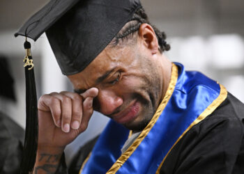 Future graduate Evan Holmes wipes his eyes after delivering a speech at the first-ever college graduation ceremony at MacDougall-Walker Correctional Institution, Friday, June 9, 2023, in Suffield, Conn. The ceremony was held under a partnership established in 2021 by the University of New Haven and the Yale Prison Education Initiative. Photo credit: Jessica Hill, The Associated Press