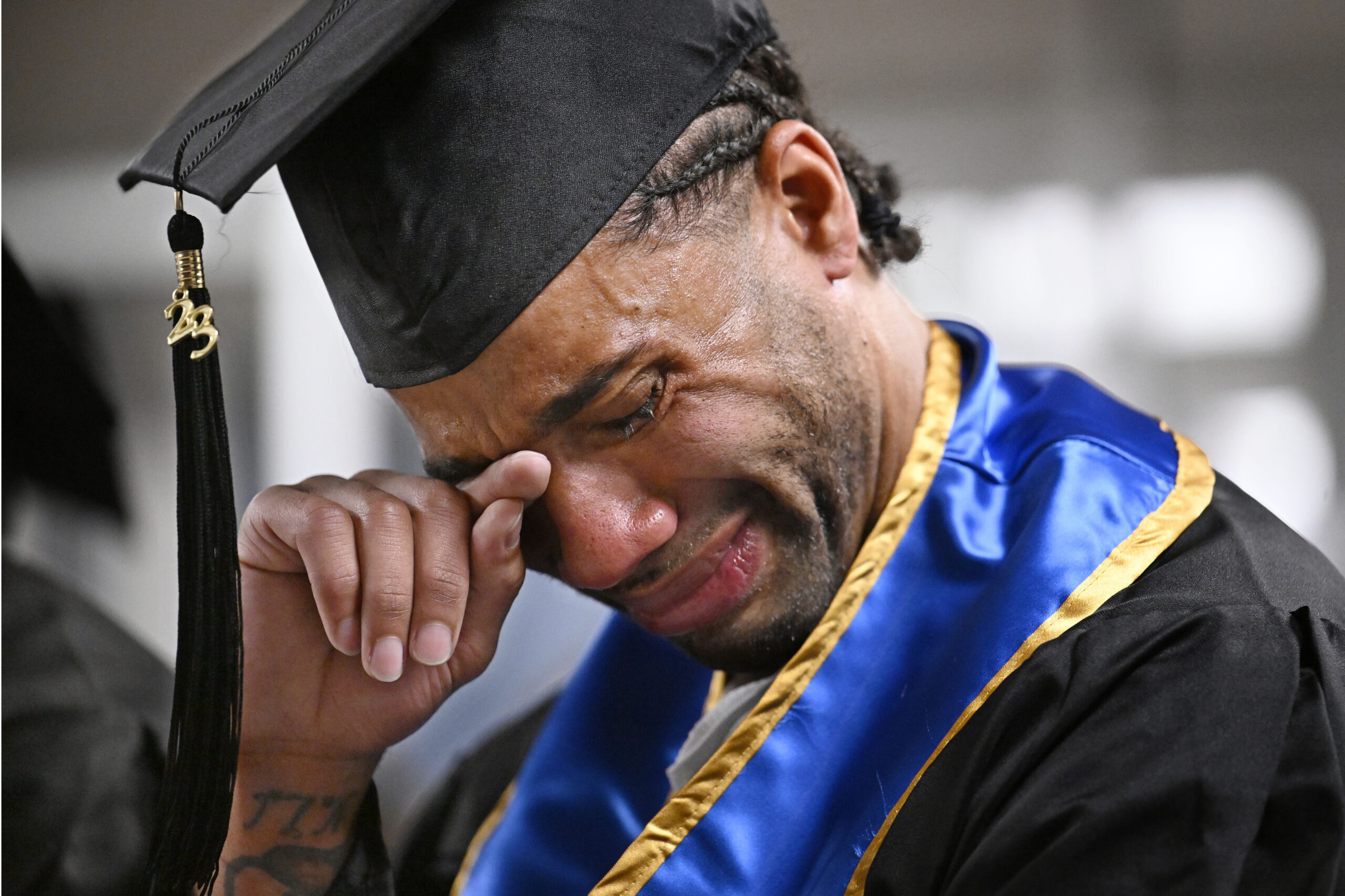 Future graduate Evan Holmes wipes his eyes after delivering a speech at the first-ever college graduation ceremony at MacDougall-Walker Correctional Institution, Friday, June 9, 2023, in Suffield, Conn. The ceremony was held under a partnership established in 2021 by the University of New Haven and the Yale Prison Education Initiative. Photo credit: Jessica Hill, The Associated Press