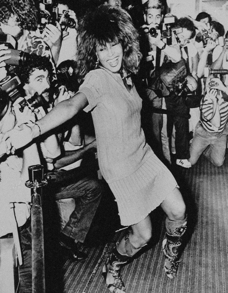 Tina Turner, then 48, is shown dancing a few steps for photographers upon arrival at the Sheraton Hotel in Buenos Aires, Argentina, on January 2, 1988.  Turner, who died in May, performed the next day at the River Plate Stadium before 60,000 fans.  Photo credit: Alejandro Querol, The Associated Press