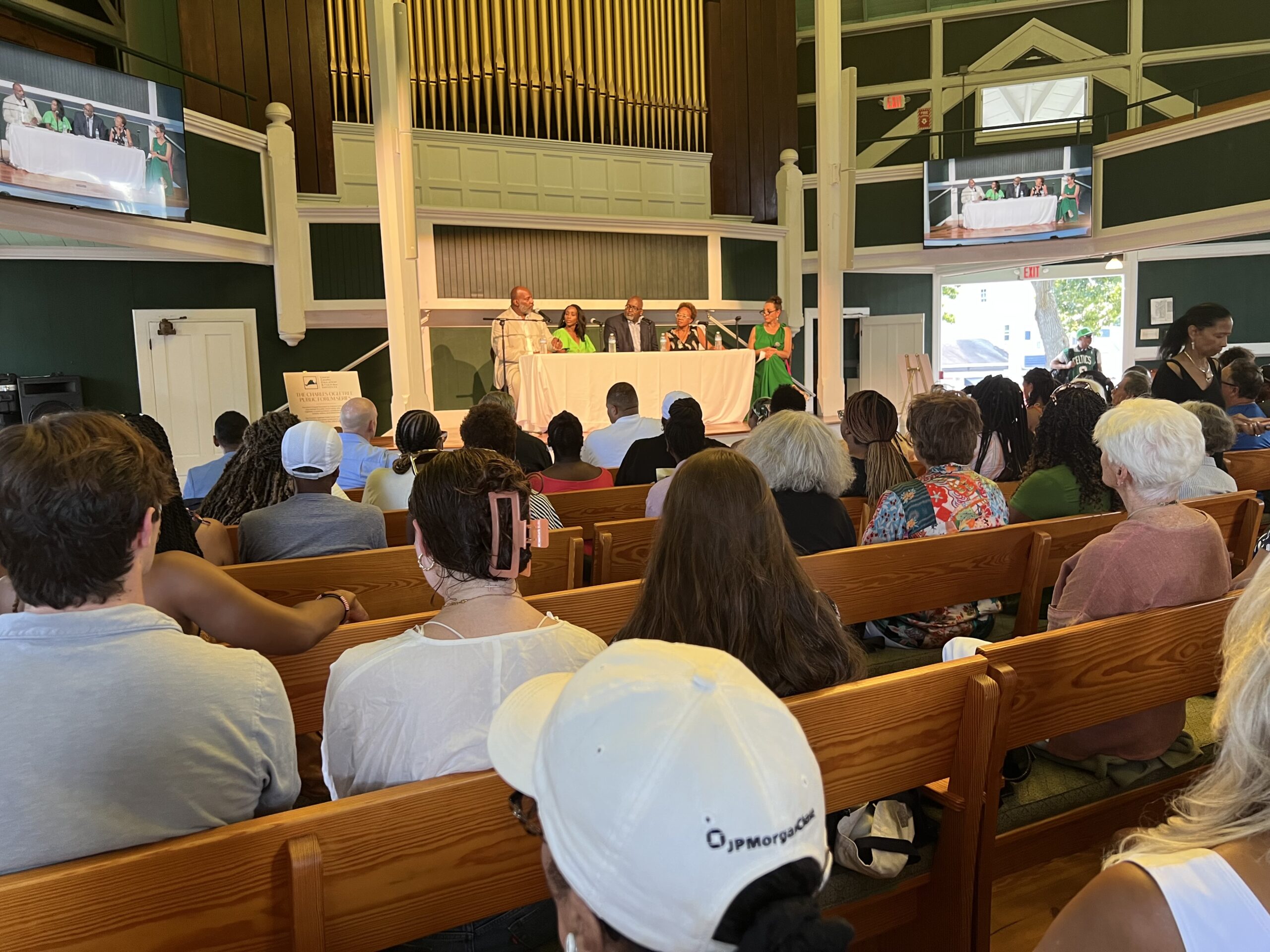 An audience at Union Chapel on Martha's Vineyard listens to prominet journalists discuss democracy and the press at an event hosted by the National Association of Black Journalists on Aug. 9, 2023, in Oak Bluffs, Massachusetts. Photo credit: Allison J. Davis, NABJ Black News & Views