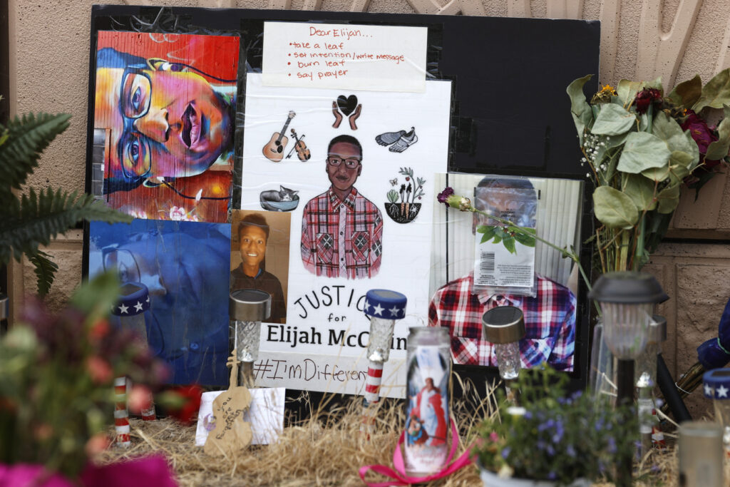 In this July 3, 2020, file photo, a makeshift memorial stands at a site across the street from where Elijah McClain was stopped by police officers while walking home in Aurora, Colo. A trial for two of the officers charged in Elijah McClain's death is set to begin Friday, Sept. 15, 2023, with jury selection. Photo credit: David Zalubowski, The Associated Press