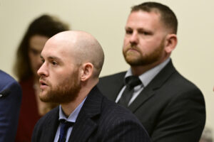 Former Aurora, Colorado, Police Officer Jason Rosenblatt, left, and suspended Police Officer Randy Roedema, right, attend an arraignment at the Adams County Justice Center in Brighton, Colorado, Jan. 20, 2023. The two officers face felony charges in the 2019 death of Elijah McClain. Photo credit: Andy Cross, The Denver Post via The Associated Press