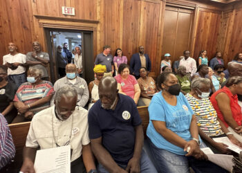 Residents, landowners and supporters of the Hogg Hummock community on Sapelo Island fill a courtroom in Darien, Georgia, on Tuesday, Sept. 12, 2023, as McIntosh County commissioners meet to approve zoning changes that some fear will endanger the Gullah enclave founded by formerly enslaved people. Commissioners voted to double the size of homes allowed in the tiny community, raising concerns that rising property values and tax increases will force out the indigenous population. Photo credit: Russ Bynum, The Associated Press