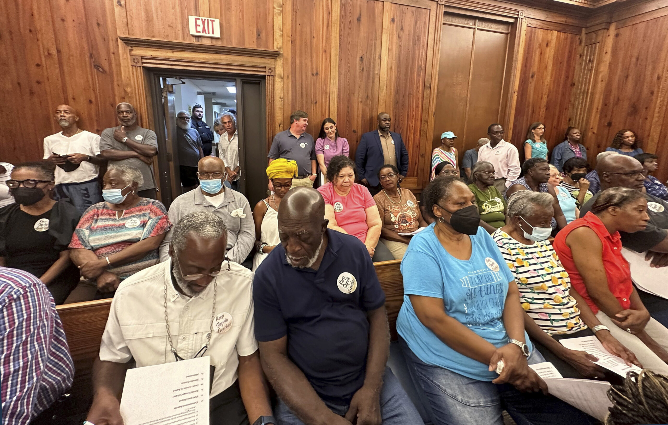Residents, landowners and supporters of the Hogg Hummock community on Sapelo Island fill a courtroom in Darien, Georgia, on Tuesday, Sept. 12, 2023, as McIntosh County commissioners meet to approve zoning changes that some fear will endanger the Gullah enclave founded by formerly enslaved people. Commissioners voted to double the size of homes allowed in the tiny community, raising concerns that rising property values and tax increases will force out the indigenous population. Photo credit: Russ Bynum, The Associated Press