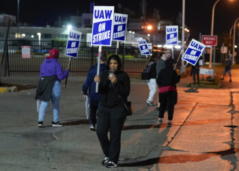Striking United Auto Workers members picket at Ford's Michigan Assembly Plant in Wayne, Michigan, early Friday, Sept. 15, 2023. Photo credit: Paul Sancya, The Associated Press