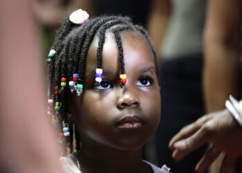 Runner-up contestant Dayanira, 4, waits to go on stage to display her hairdo during an Afro hair contest in Havana, Cuba, Saturday, June 13, 2015. Behind closed doors and even in public, white Cubans talk disparagingly about black Cubans in ways that have become socially unacceptable in many other countries, describing them as criminals and forbidding their children from dating Afro-Cuban schoolmates. Photo credit: Desmond Boylan, The Associated Press