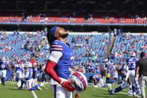 Buffalo Bills safety Damar Hamlin removes his helmet while warming up prior to an NFL football game against the Miami Dolphins, Sunday, Oct. 1, 2023, in Orchard Park, New York. Photo credit: Jeffrey T. Barnes, The Associated Press