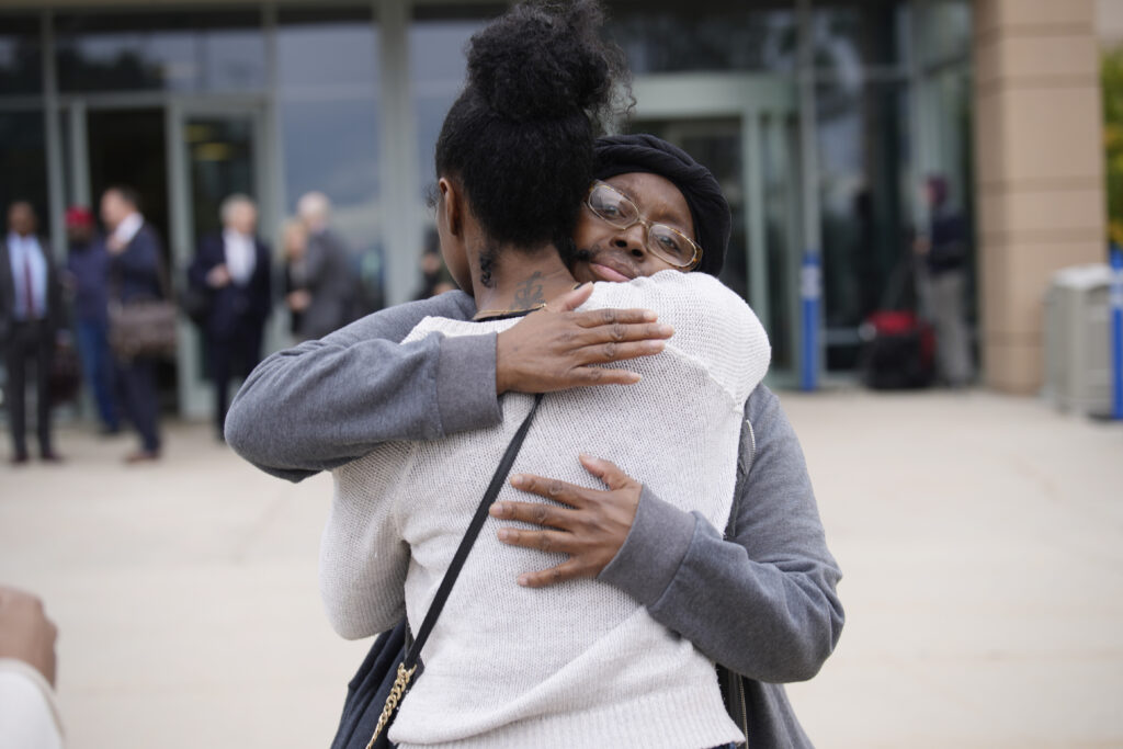 Sheneen McClain, mother of Elijah McClain, back, is hugged by a supporter as they leave the Adams County, Colorado, courthouse after a trial for the two former Aurora Police Department officers facing charges in the 2019 death of her son on Thursday, Oct. 12, 2023, in Brighton, Colorado. Photo credit: David Zalubowski, The Associated Press