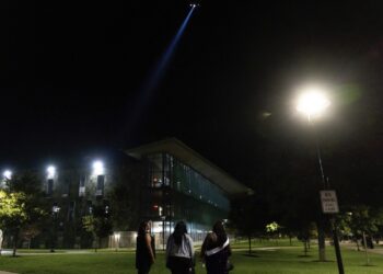 Students watch as a police helicopter flies over Morgan State University after a shooting, Wednesday, Oct. 4, 2023, in Baltimore. Photo credit: Julia Nikhinson