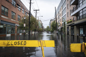 A flooded street due to heavy rain is blocked in Hoboken, New Jersey, on Friday, Sept. 29, 2023. Photo credit: Stefan Jeremiah, The Associated Press