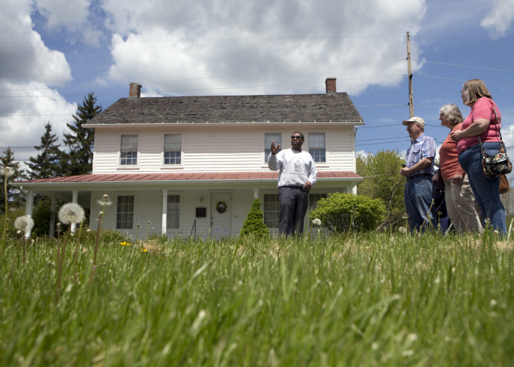 In this Thursday, May 19, 2016 file photo, Rev. Paul Gordon Carter, manager of the Harriet Tubman Home, leads a tour at the historic site in Auburn, New York. Photo credit: Mike Groll, The Associated Press