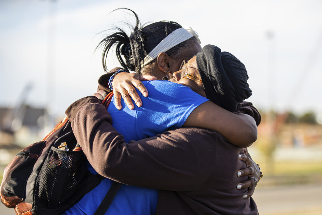Sheneen McClain, right, mother of Elijah McClain, and friend and supporter MiDian Holmes embrace after suspended Aurora, Colorado, Police Officer Nathan Woodyard was acquitted in the 2019 death of Elijah, outside of the Adams County Justice Center on Monday, Nov. 6, 2023, in Brighton, Colorado. Photo credit: Hart Van Denburg, Colorado Public Radio via The Associated Press