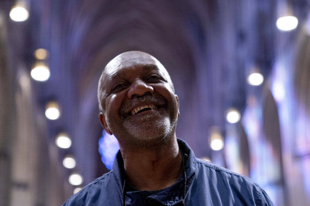 Artist Kerry James Marshall stands in the main hall of the National Cathedral after being selected to design a replacement of former confederate-themed stained glass windows that were taken down in 2017, in Washington, Thursday, Sept. 23, 2021. The Cathedral has also commissioned Pulitzer-nominated poet Elizabeth Alexander to pen a poem that will be inscribed in the stone beneath the new windows. Photo credit: Andrew Harnik, The Associated Press