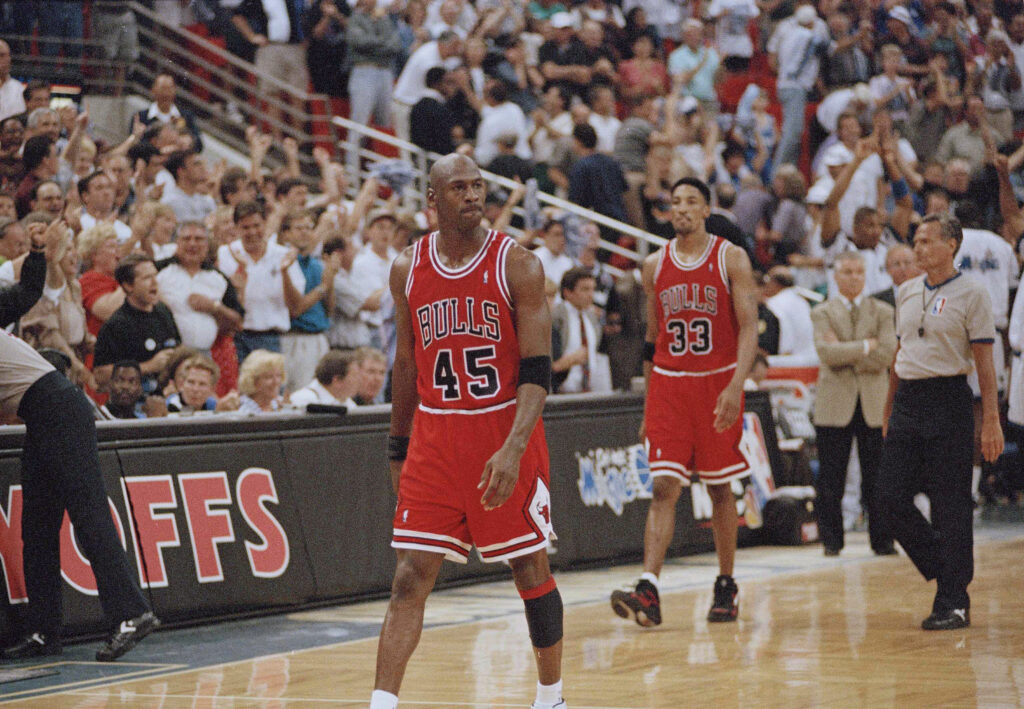 Chicago Bulls guard Michael Jordan (45) and forward Scottie Pippen (33) walk back to the bench during a timeout with 1.5 seconds left and the Orlando Magic leading 94-91 during their first  playoff game in Orlando, May 7, 1995. The Magic won by the same score. Photo credit: Robert Baker, The Associated Press